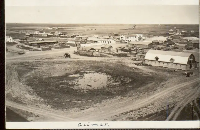 Aerial view of Climax with early buildings and a slough